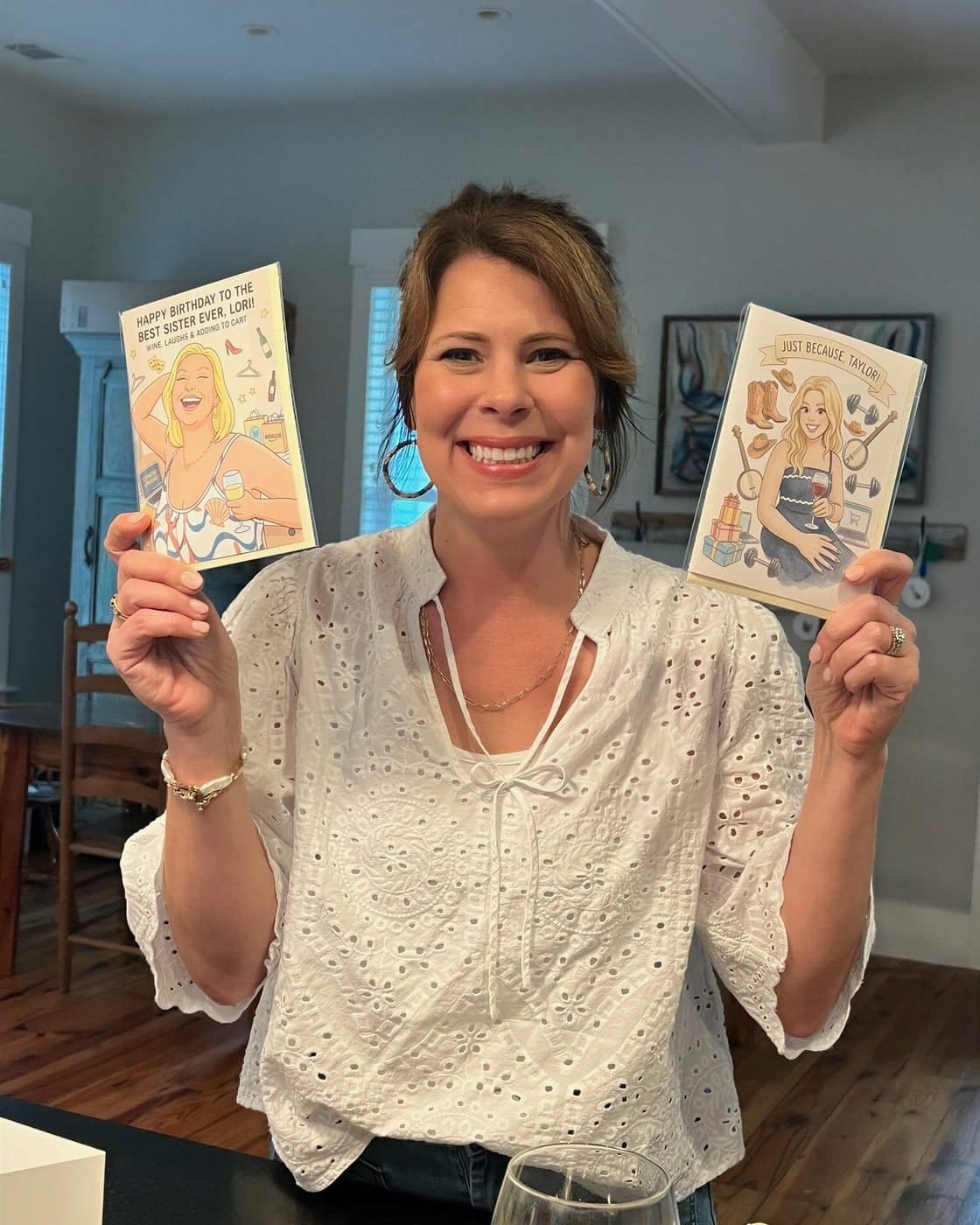 A woman holding two personalized P.S. cards
